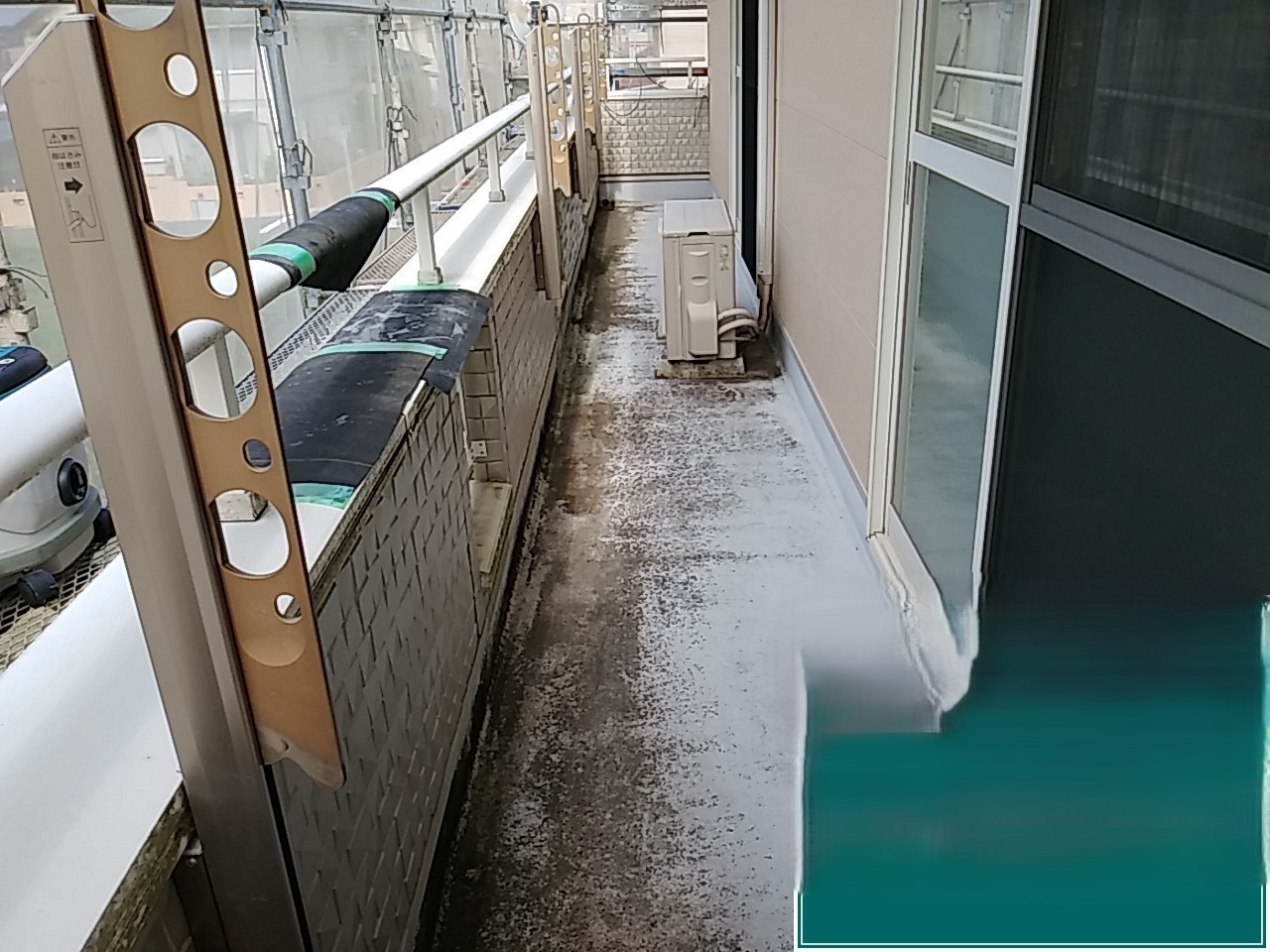 ベランダ床に広がる黒ずみと色ムラを確認